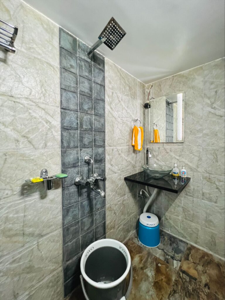 Megh Villa, Alibag: Bathroom with a glass bowl basin and an overhead shower