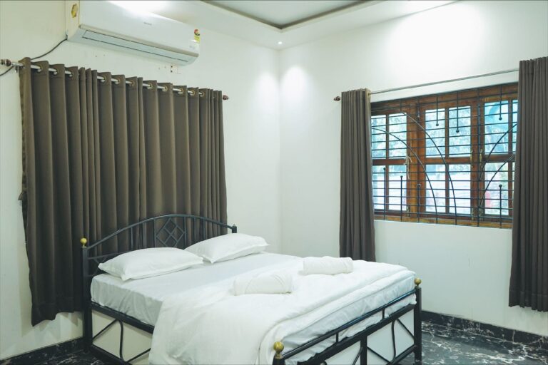 Megh Villa, Alibag: Bedroom with a black metal bed frame