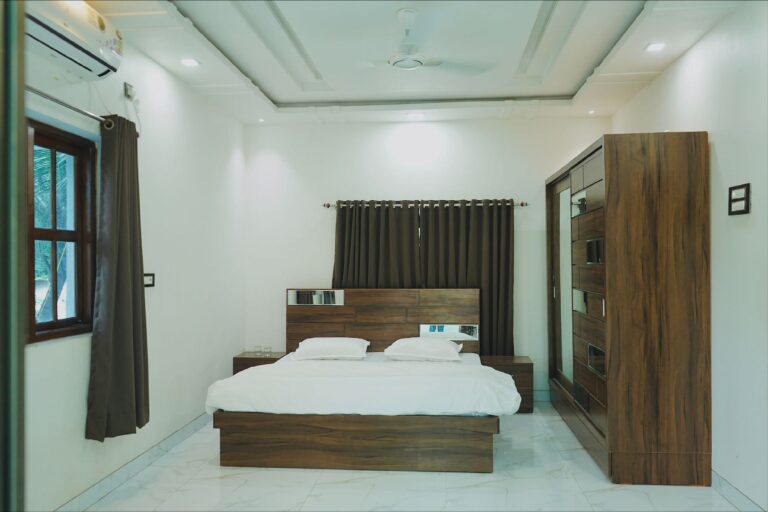 Megh Villa, Alibag: Bedroom with a wooden bed and a sliding wardrobe