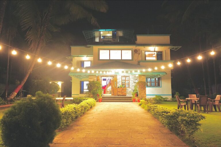 Megh Villa, Alibag: The villa after dark, with string lights over the lawn