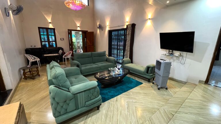 Megh Villa, Alibag: Sofas, coffee table and wall TV in the living hall