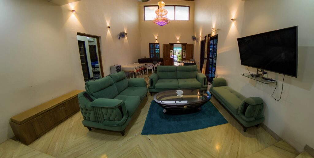 Megh Villa, Alibag: The double-height living hall, with the dining table and foosball beyond