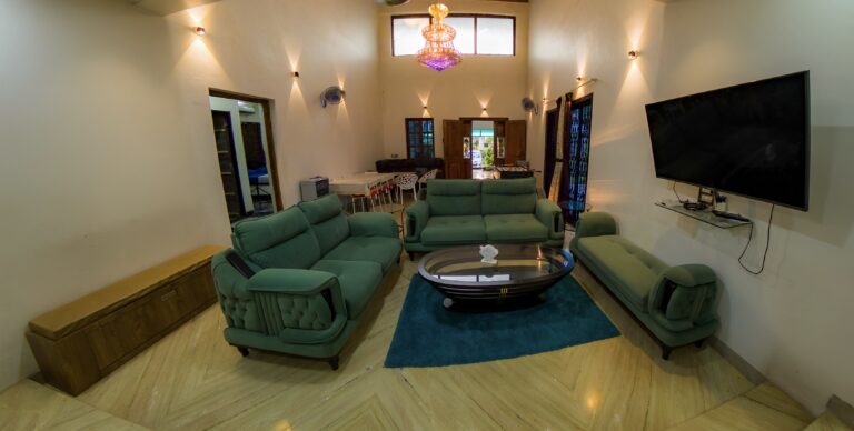 Megh Villa, Alibag: The double-height living hall, with the dining table and foosball beyond